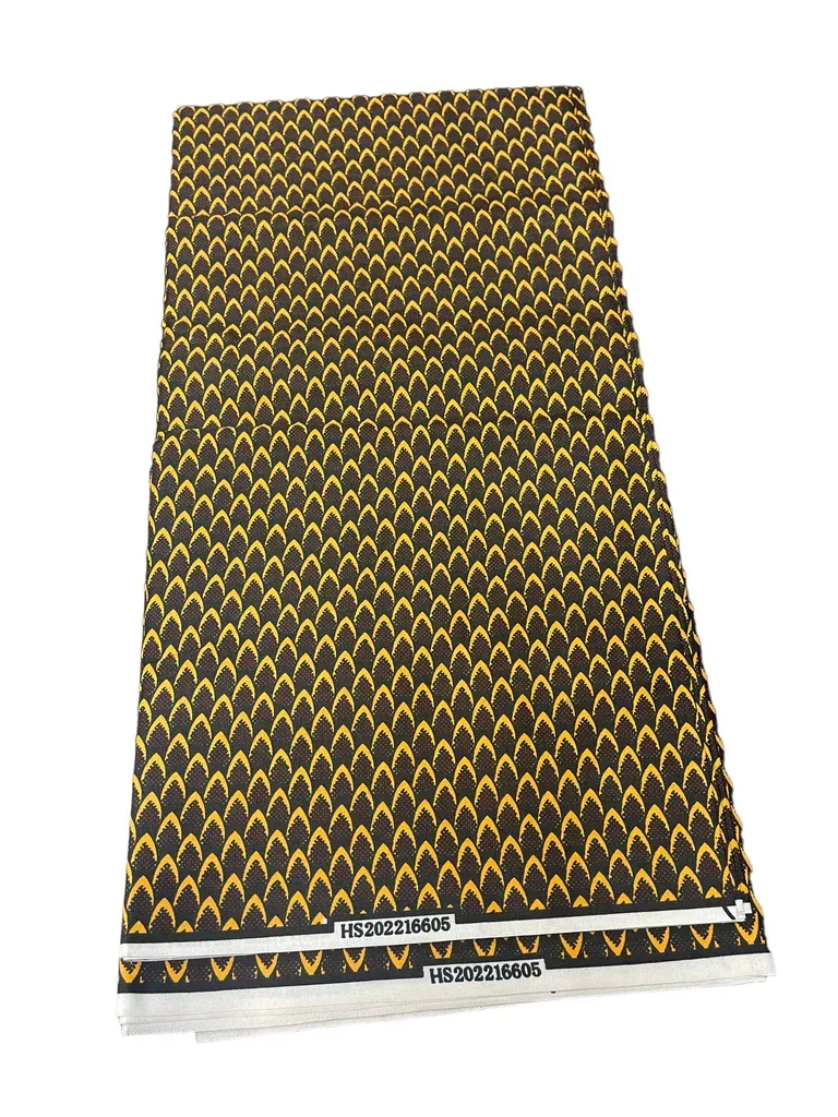 Yellow and black patterned woven fabric laid flat, with a decorative border at the bottom.