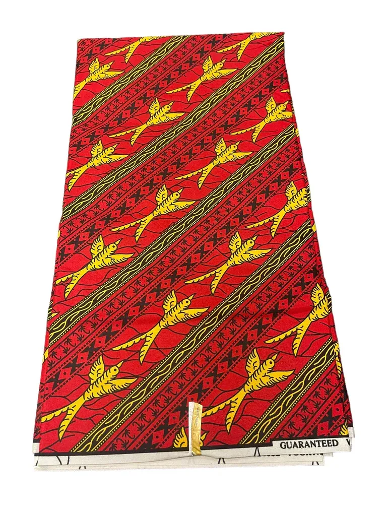 Red patterned fabric with yellow diagonal stripes and star motifs, displayed vertically
