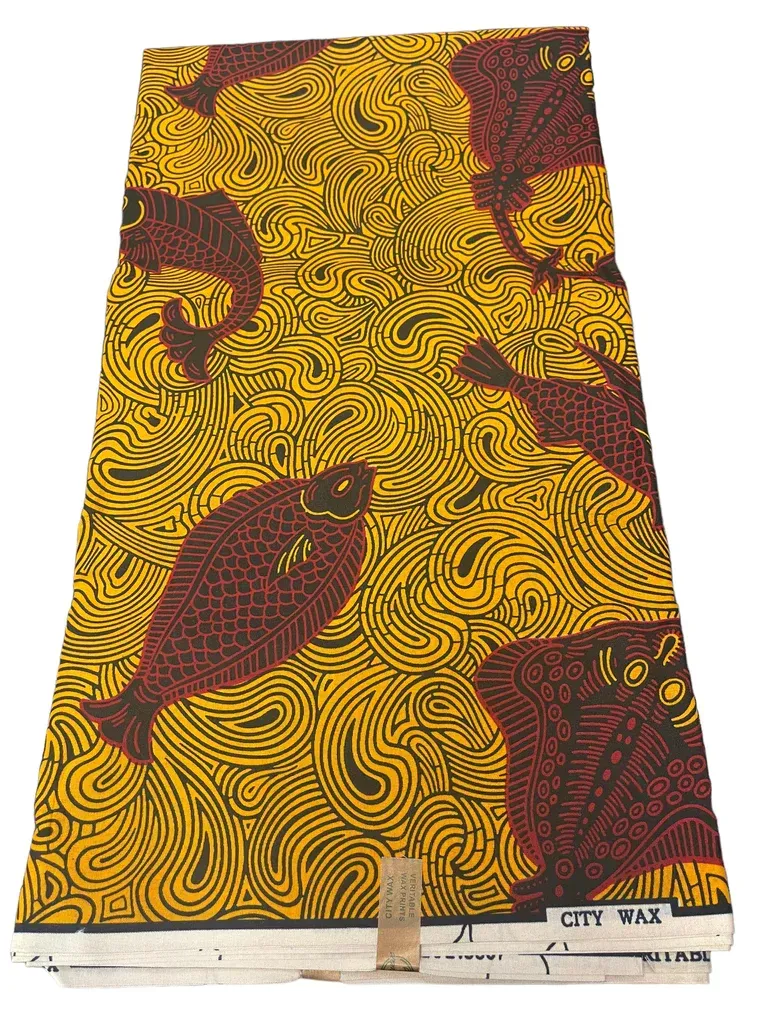 Yellow patterned textile with maroon bird motifs hanging against a white background
