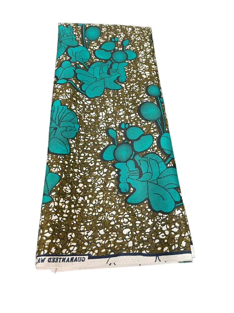 Folded fabric with teal floral patterns on a brown background