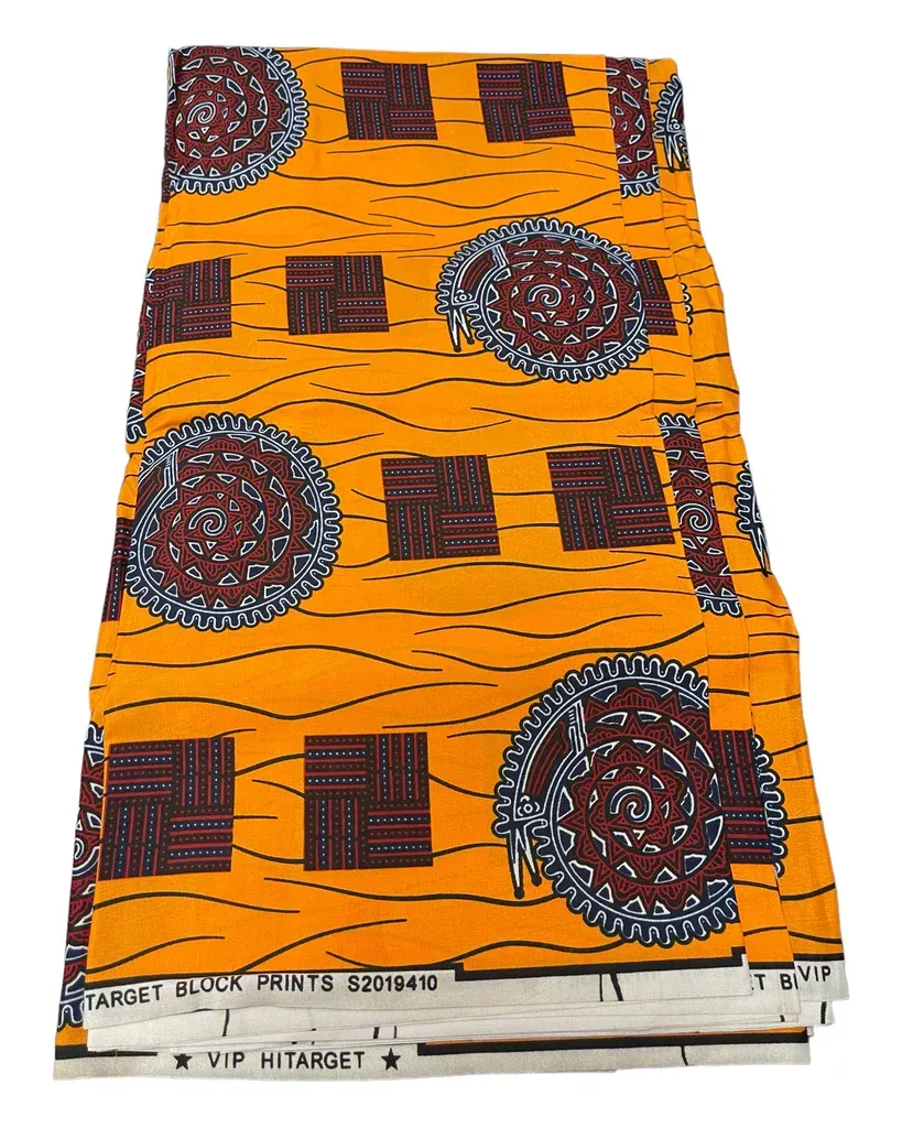 Orange patterned fabric with maroon and black geometric and circular designs