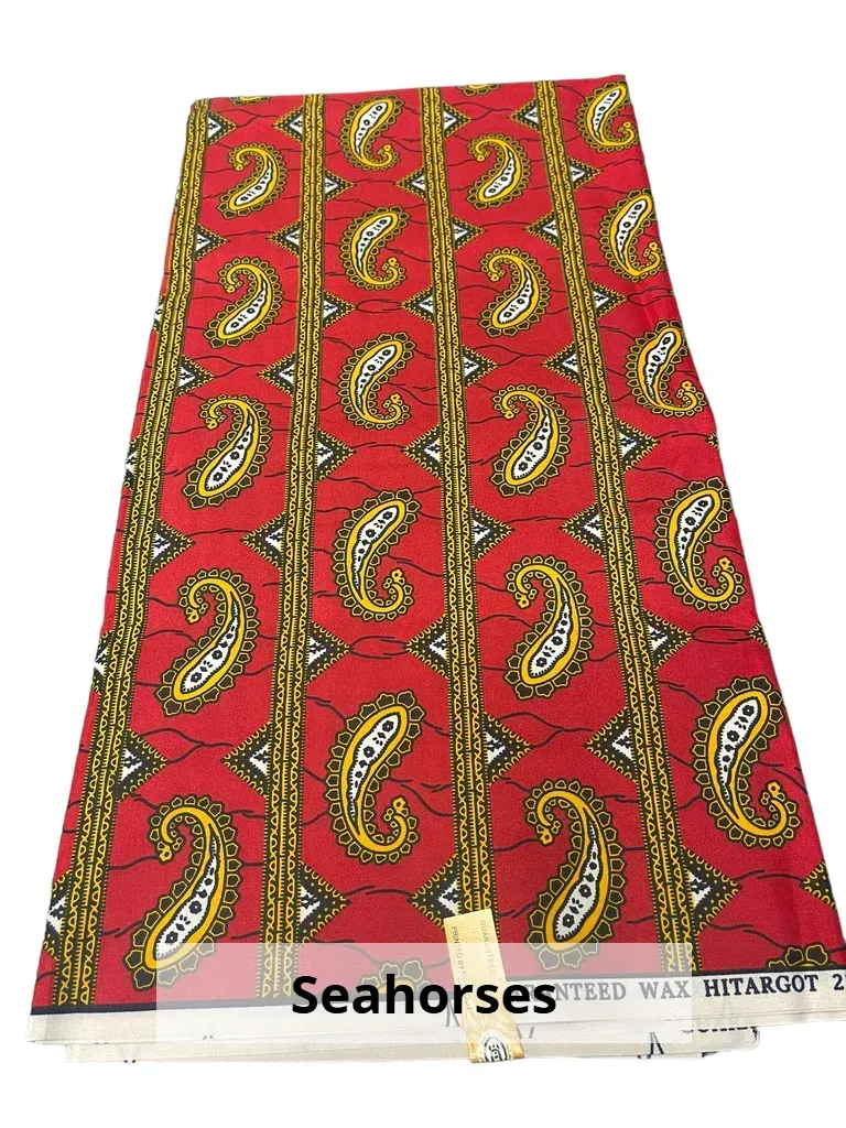 Red fabric with repeating gold seahorse pattern on a flat surface