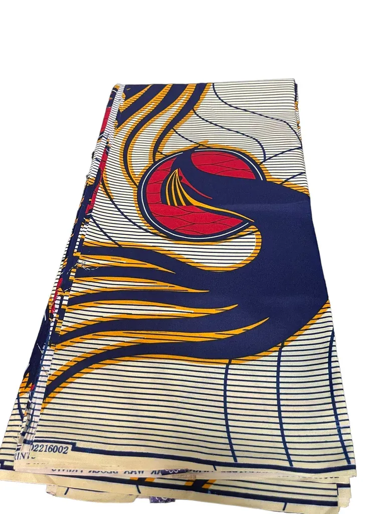 Colorful patterned fabric with navy, gold, white, and red swirls folded into a draped shape