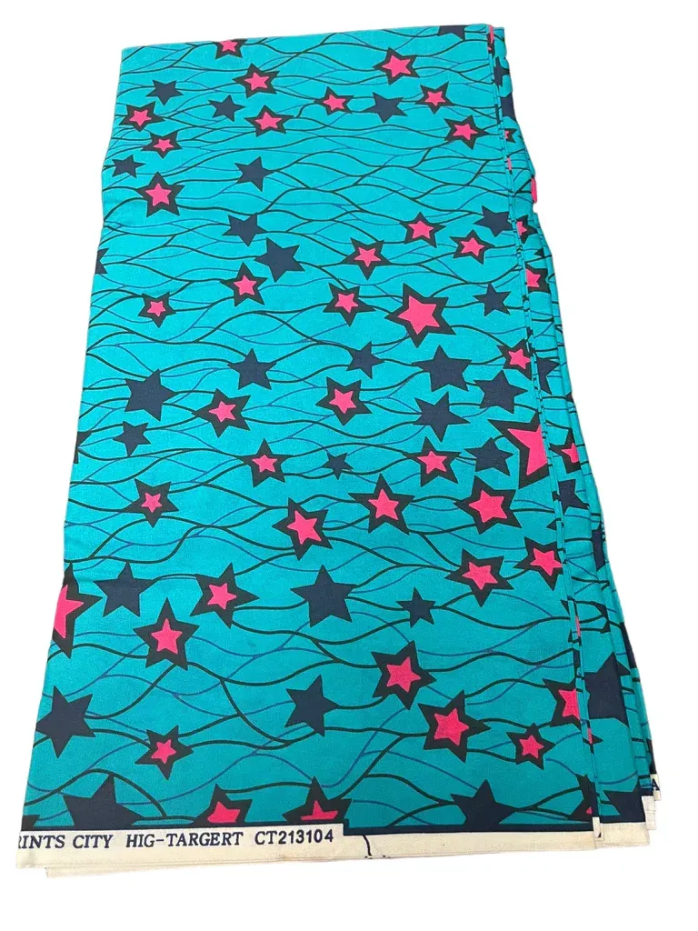 Blue fabric with pink stars and black abstract lines, laid flat on a white background.