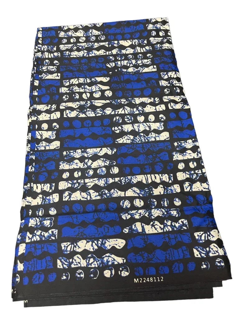 Folded black fabric with blue and white patterned print on a white background