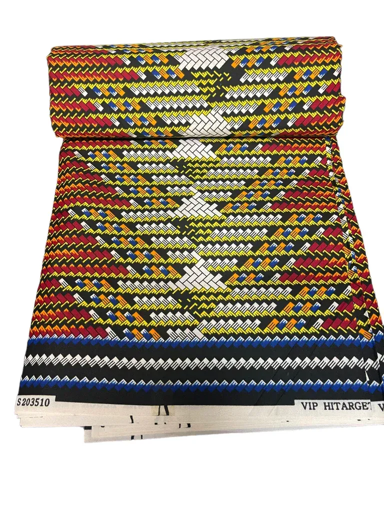 Colorful patterned woven textile with geometric stripes and white zigzag motifs on a display panel