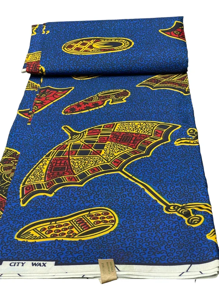 Blue patterned fabric with red and yellow motifs, folded and secured with a small clip.