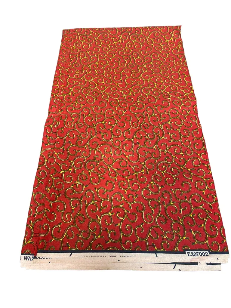 Red floral-patterned dress laid flat on a white background