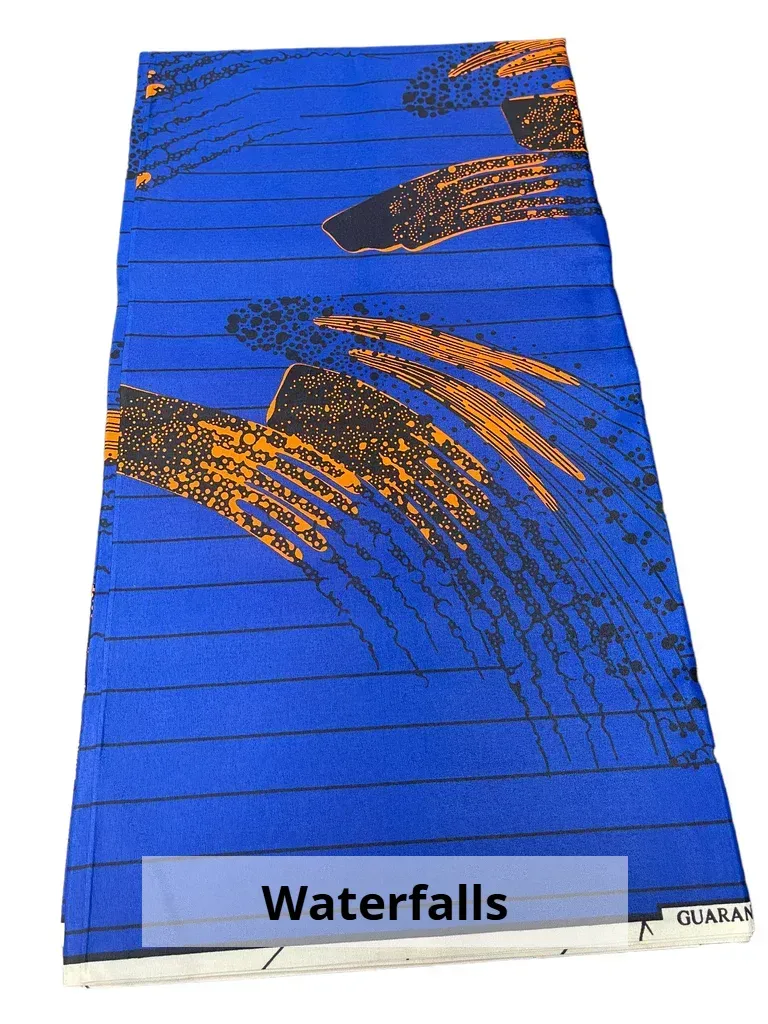 Blue “Waterfalls” textile with orange abstract waterfall patterns