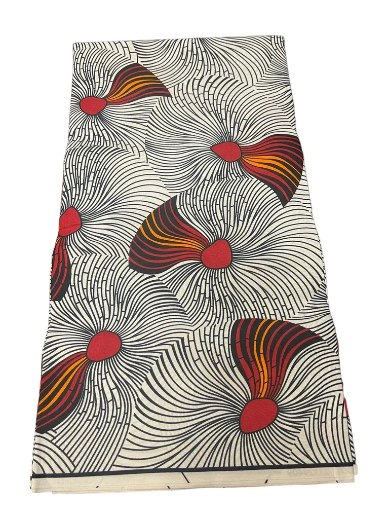 Patterned fabric with black-and-white swirls and red, orange, and yellow leaf-like shapes
