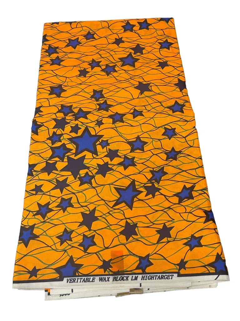Orange patterned mattress with blue stars, shown at an angle on a white background