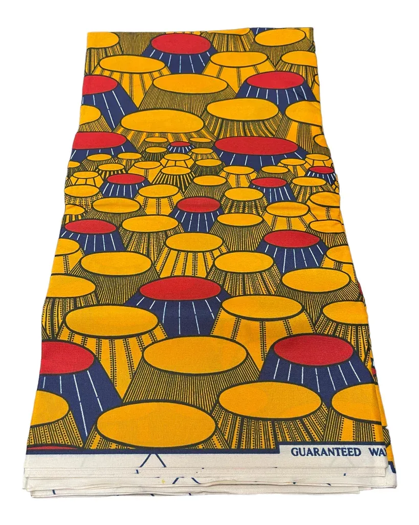 Colorful patterned paperback book cover with abstract yellow, red, and blue shapes