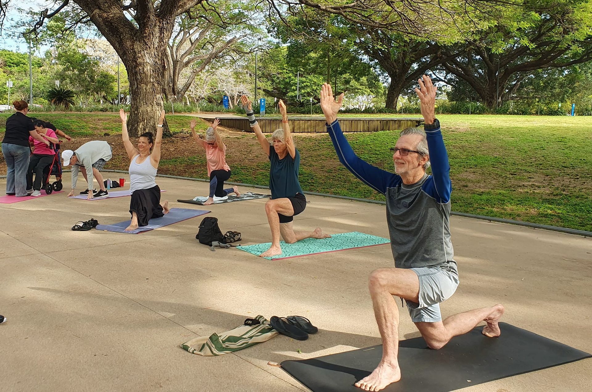 Group of People Doing Yoga Outdoors in a Park — Skilful Living in North Ward, QLD