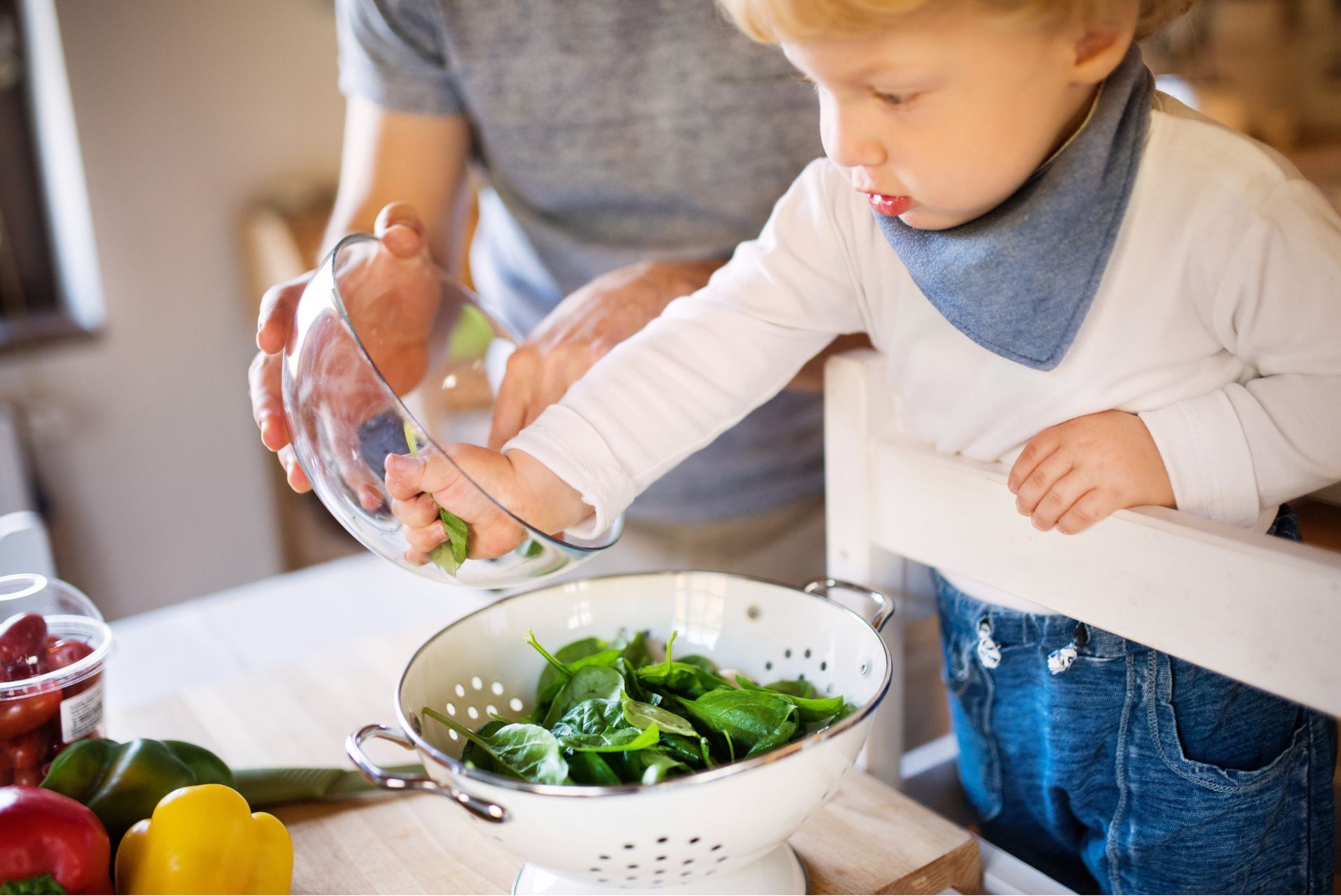 montessori toddler helping prepare meal