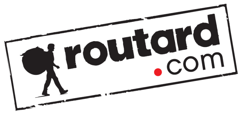 Rotated Routard.com logo in black and red with a walking figure and red dot