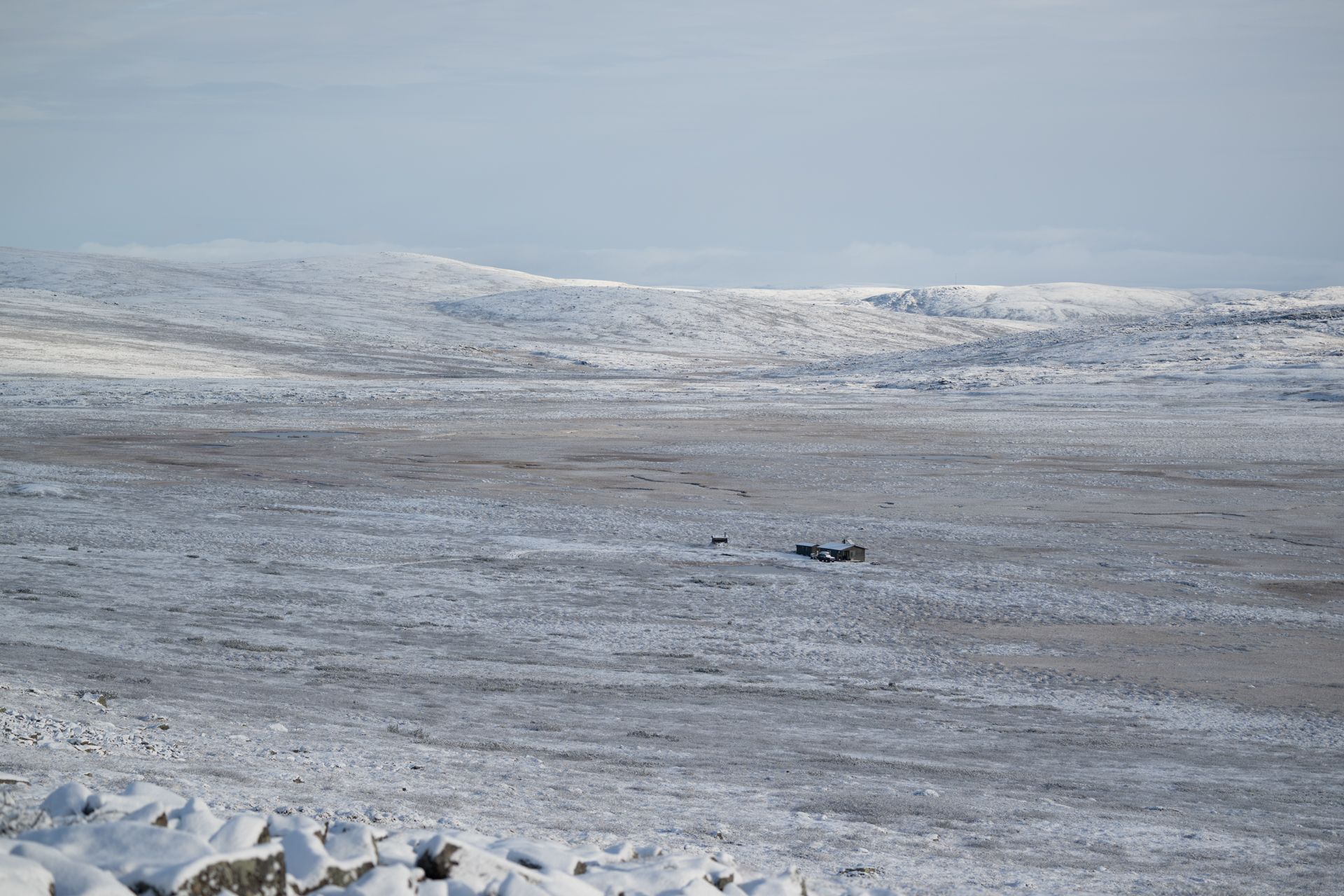 A snowy landscape with mountains in the background