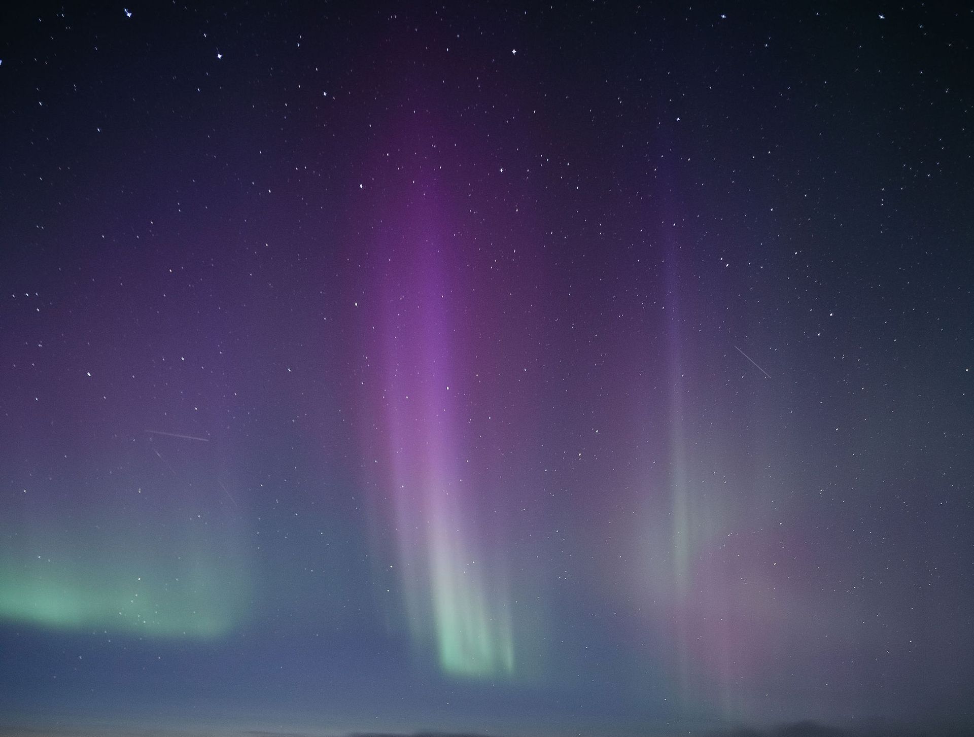 The aurora borealis is glowing in the night sky.