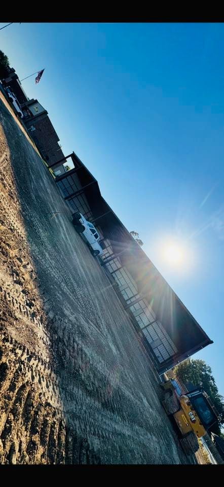 Bright sunny sky over a building under construction. A flag is visible.