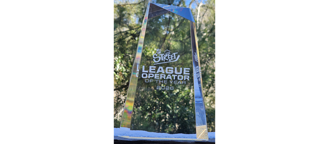 Blue banner with white “League Operation” text hanging among trees outdoors