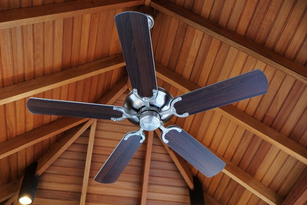 A Ceiling Fan is Hanging From a Wooden Ceiling — A J Wilcox Air & Electrical in Banora Point, NSW