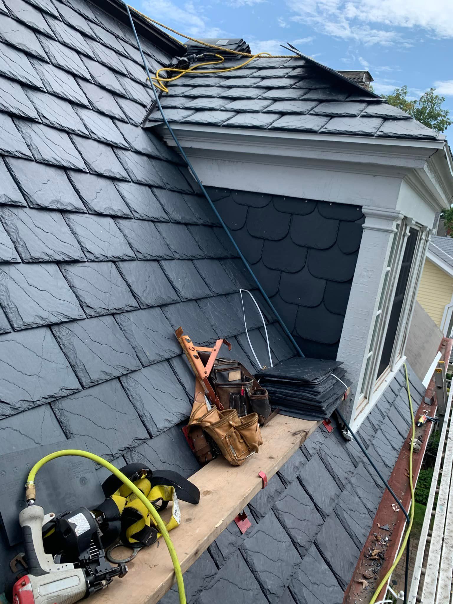 A slate roof is being installed on a house.