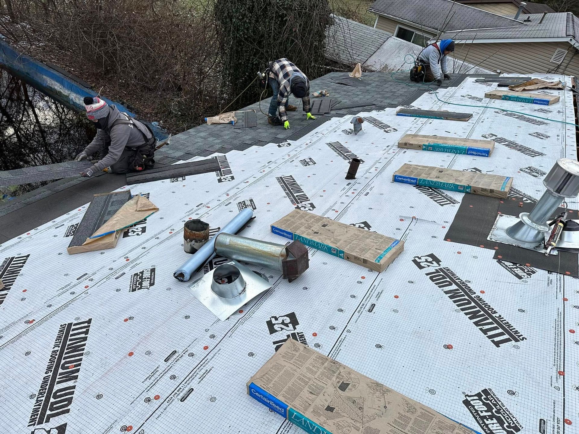 A man is working on the roof of a house.