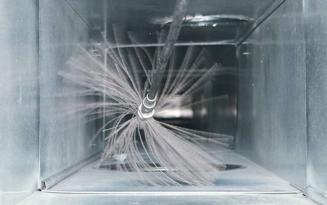 Professional air duct cleaning service inside a home HVAC system
