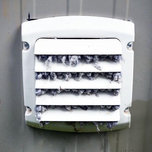 White outdoor vent with horizontal slats, clogged with thick white fuzz or snow-like debris. Blue Bell, PA