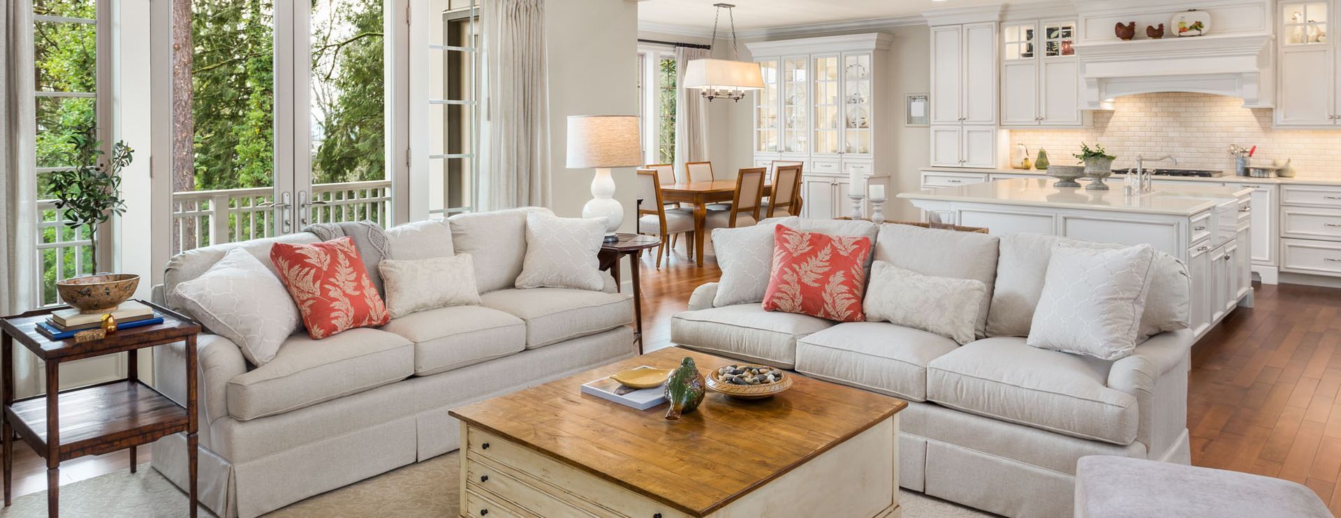 Living room with fireplace, gray sofa, armchair, rug, and coffee table.
