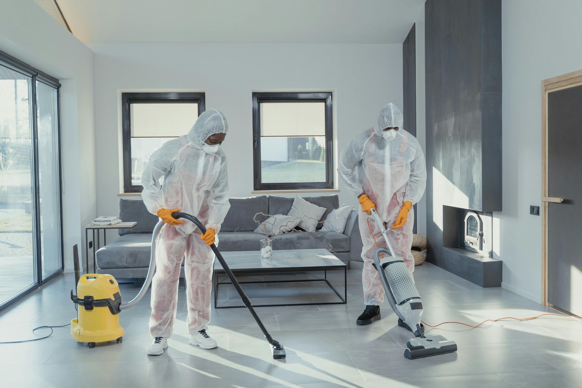 Person installs carpet on stairs with a hammer and stretcher tool. Light beige carpet.