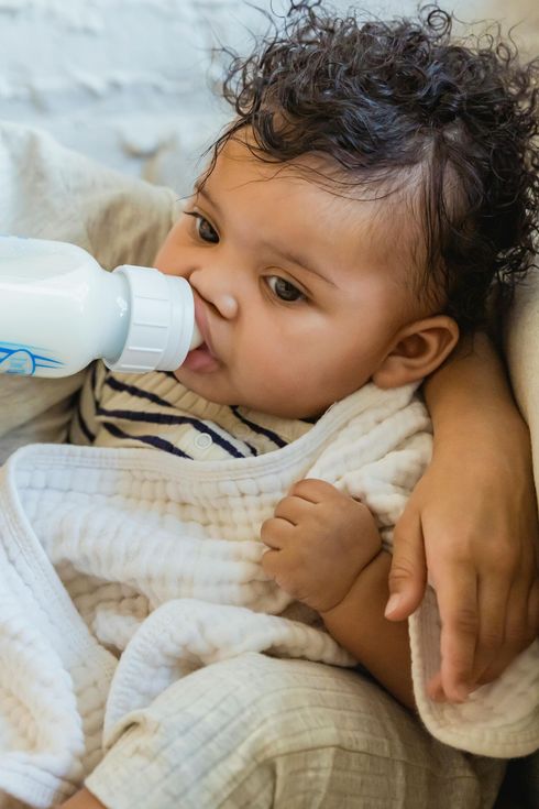 child safely enjoying their bottle