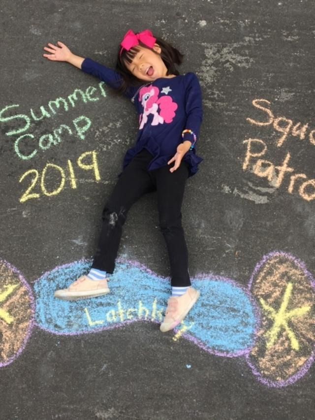 Girl poses on chalk art, 
