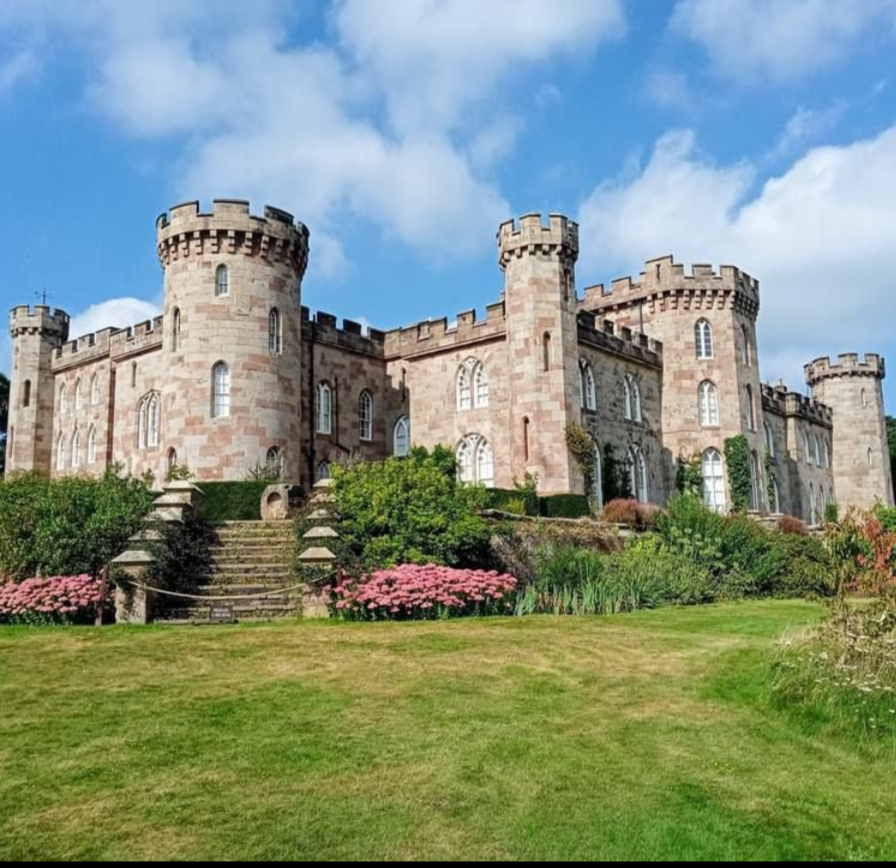 A large castle with a blue sky in the background