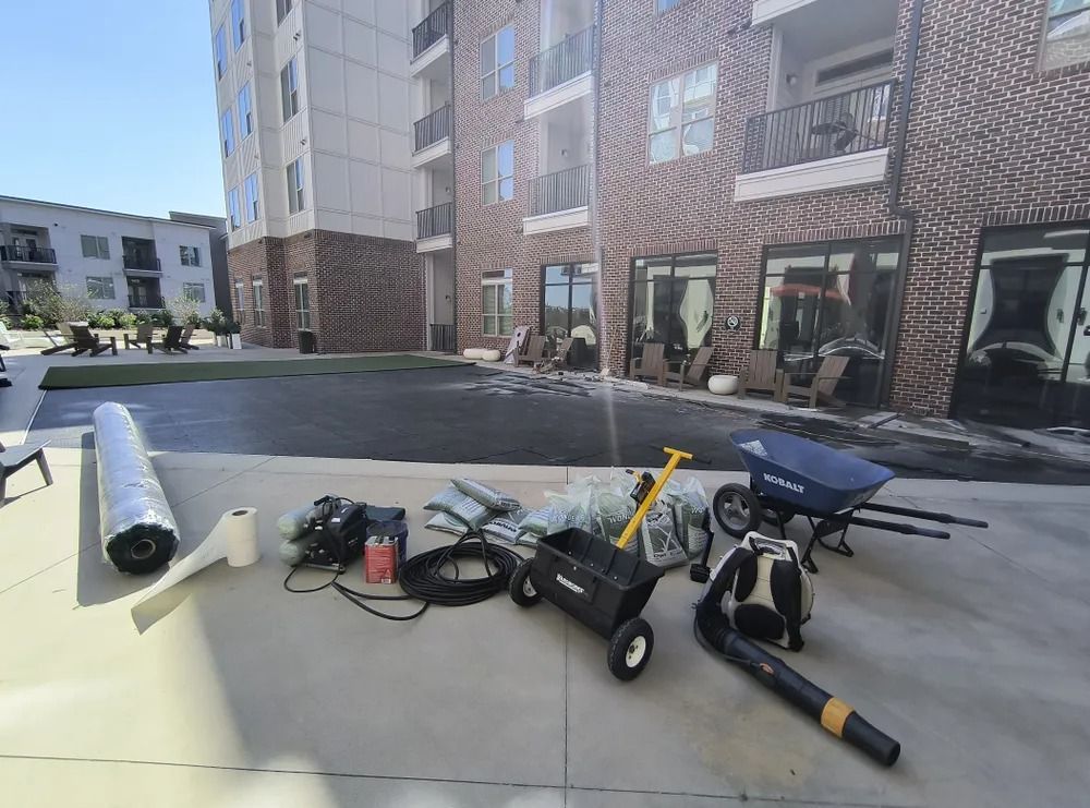 Construction tools and materials on a rooftop patio beside apartment buildings