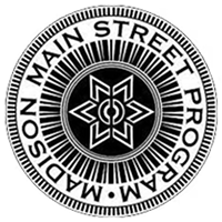 Circular black-and-white seal reading “Madison Main Street Program” with a geometric star logo in the center