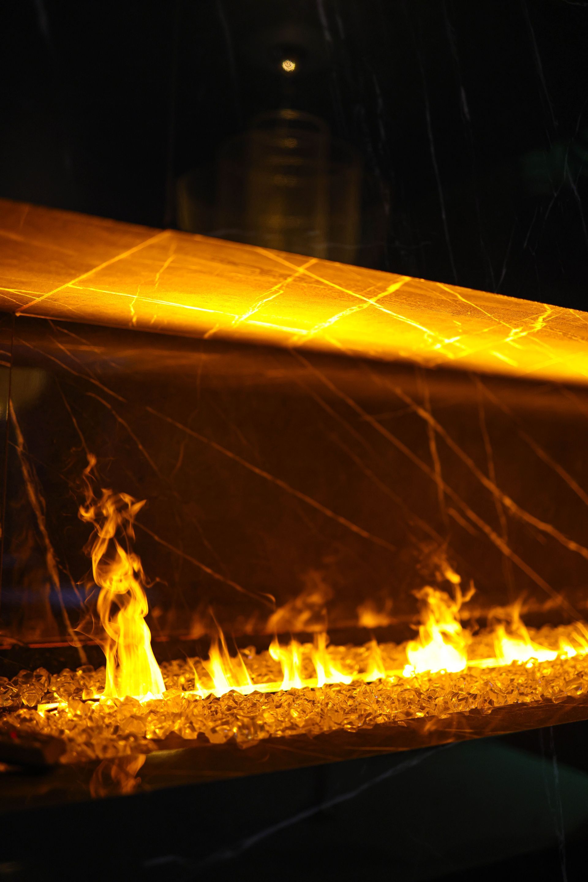 Glowing metal bar with sparks and flames in a dark industrial setting