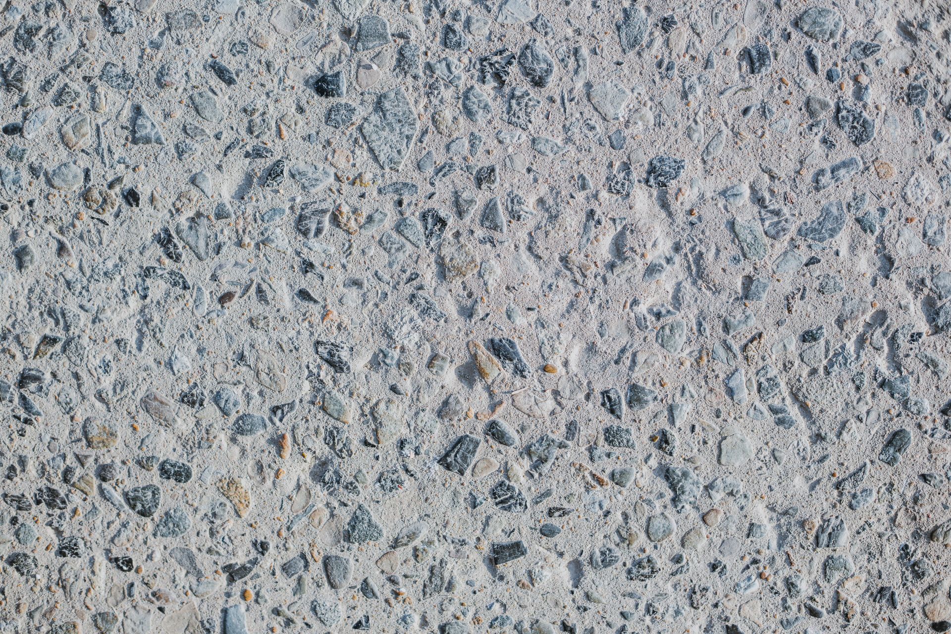 Close-up of a gray and blue speckled stone or concrete surface