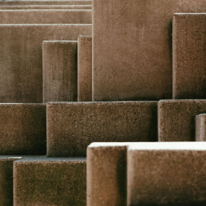 Brown abstract geometric blocks with varying heights and textured surfaces