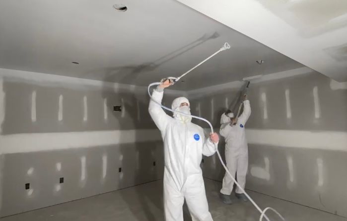 An empty room with white cabinets and wooden floors