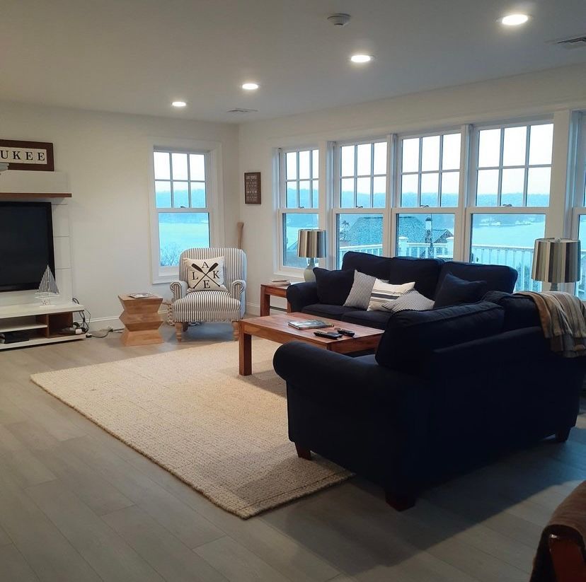 A large empty basement with hardwood floors and stairs.