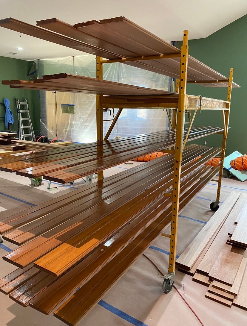 A room with a wooden ceiling and hardwood floors