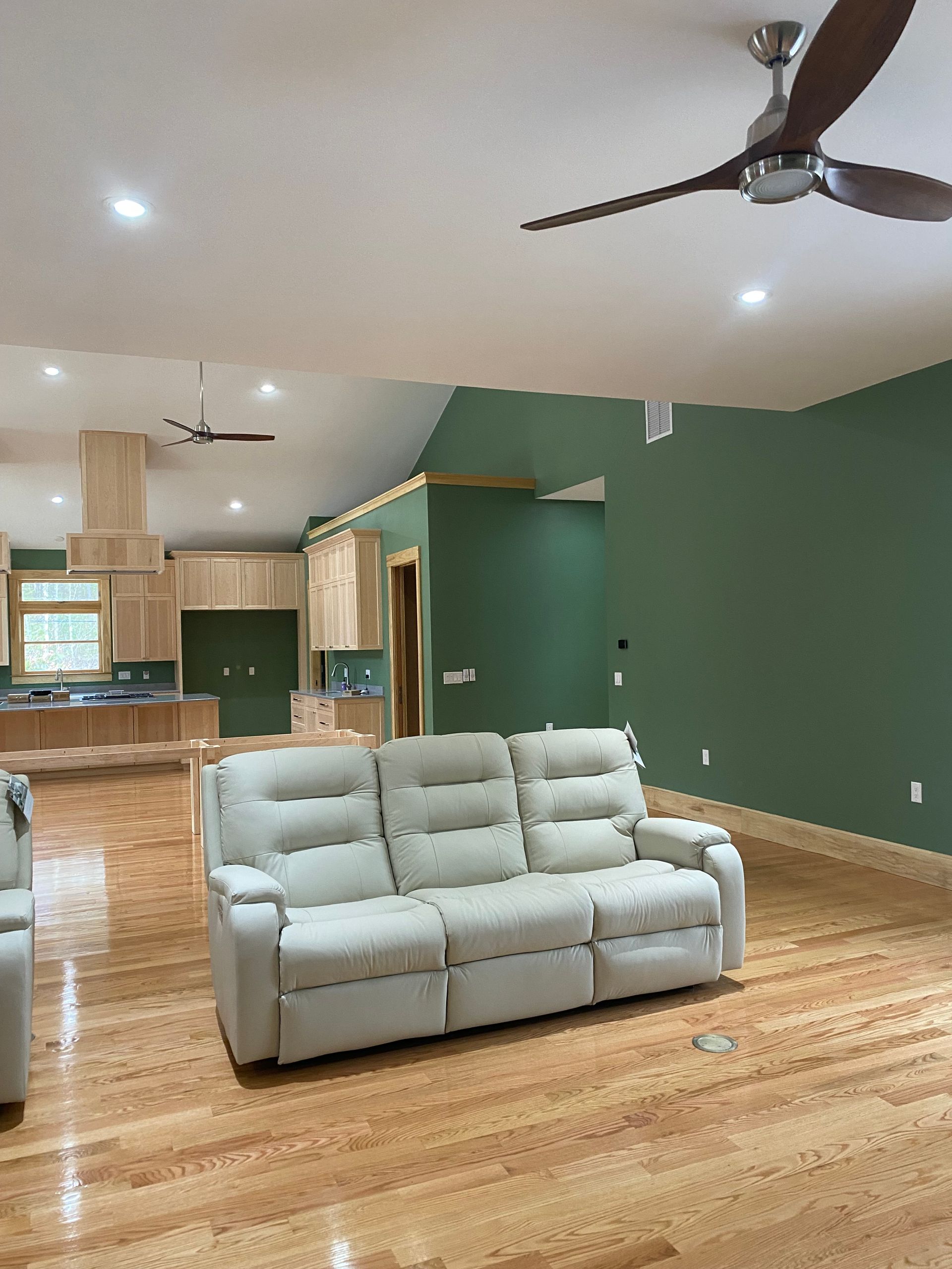 A living room with a couch and a ceiling fan