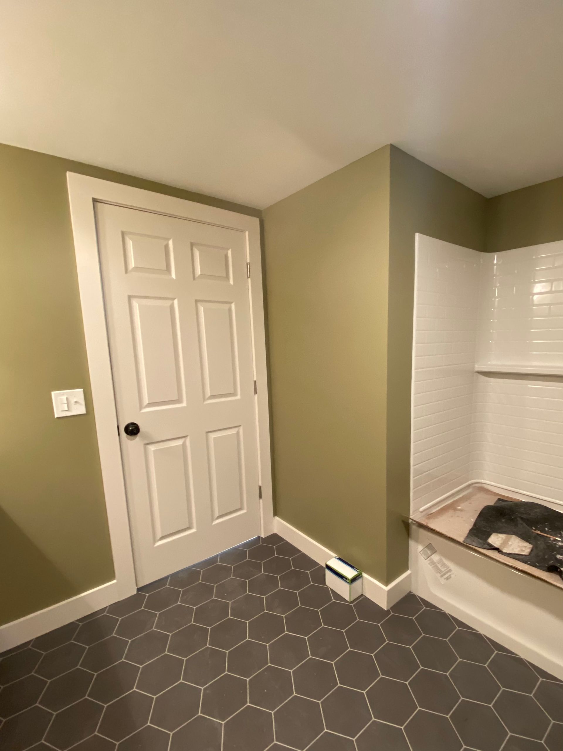 A bathroom with a bathtub and a door.