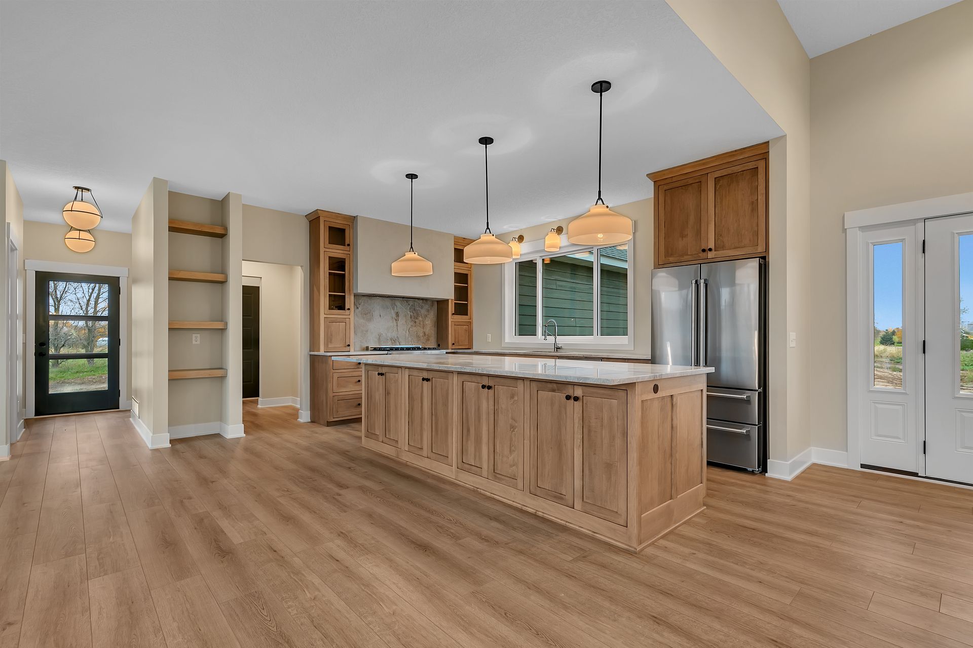 A kitchen with a large island and stainless steel appliances