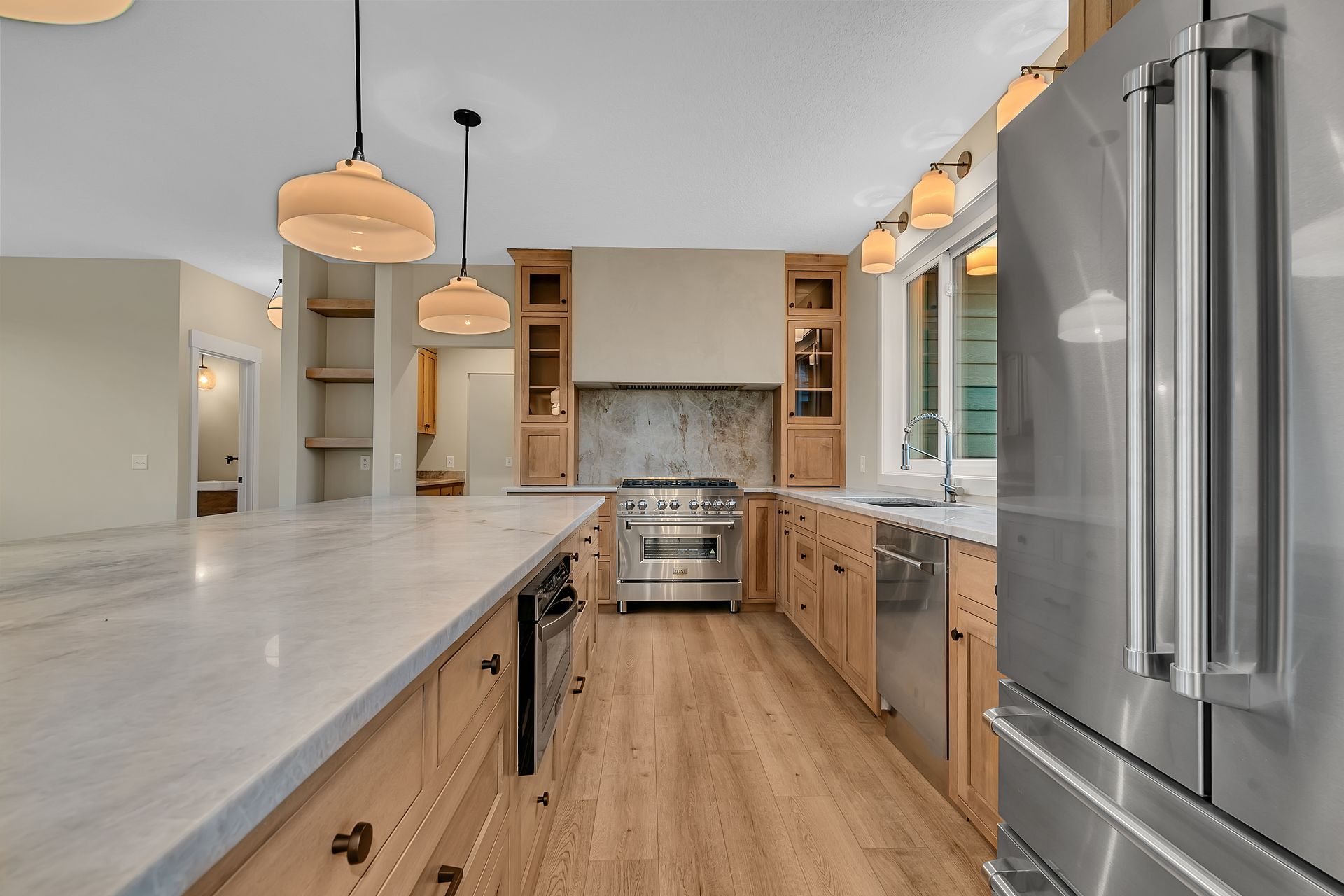 A kitchen with stainless steel appliances and wooden cabinets.