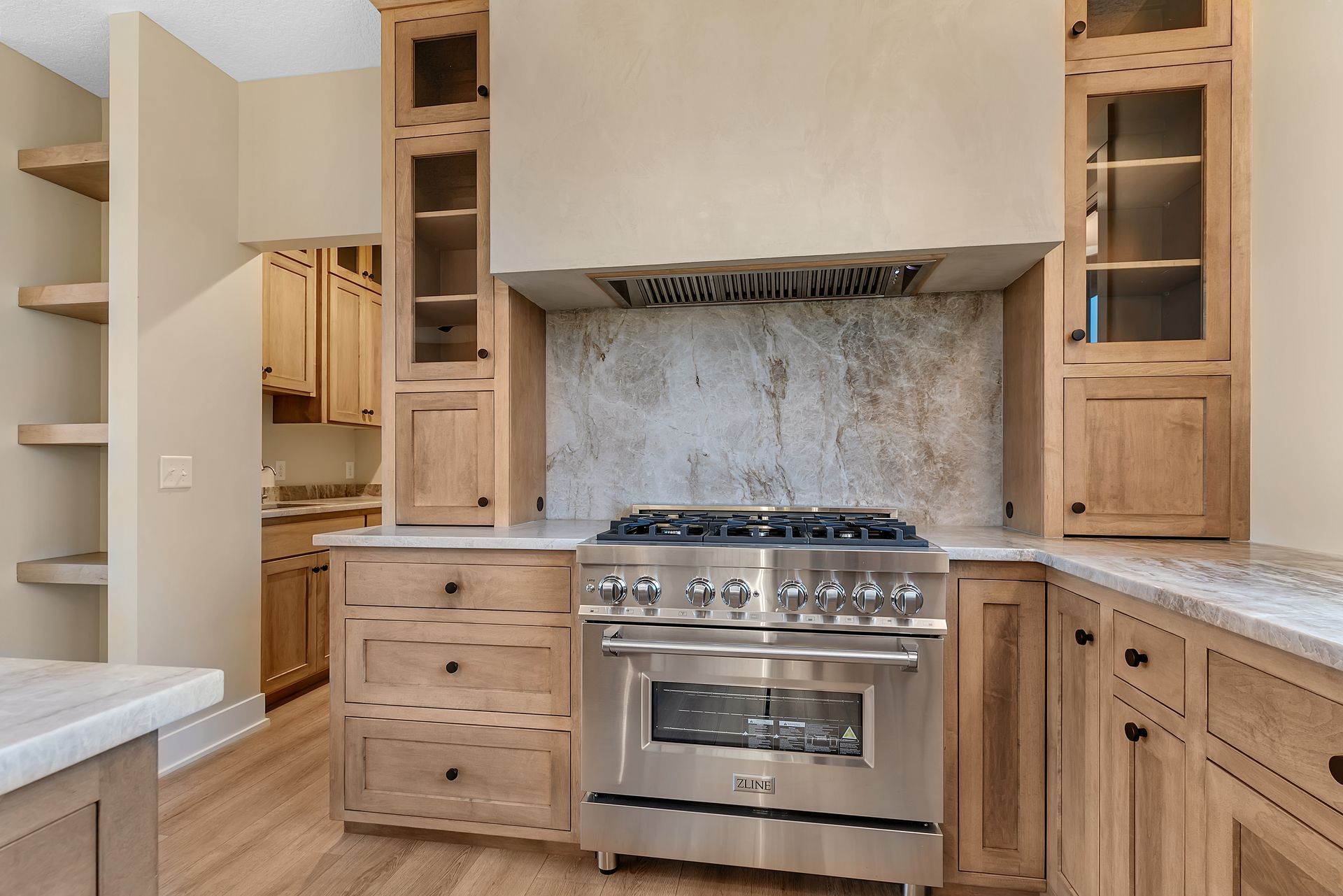 A kitchen with stainless steel appliances and wooden cabinets