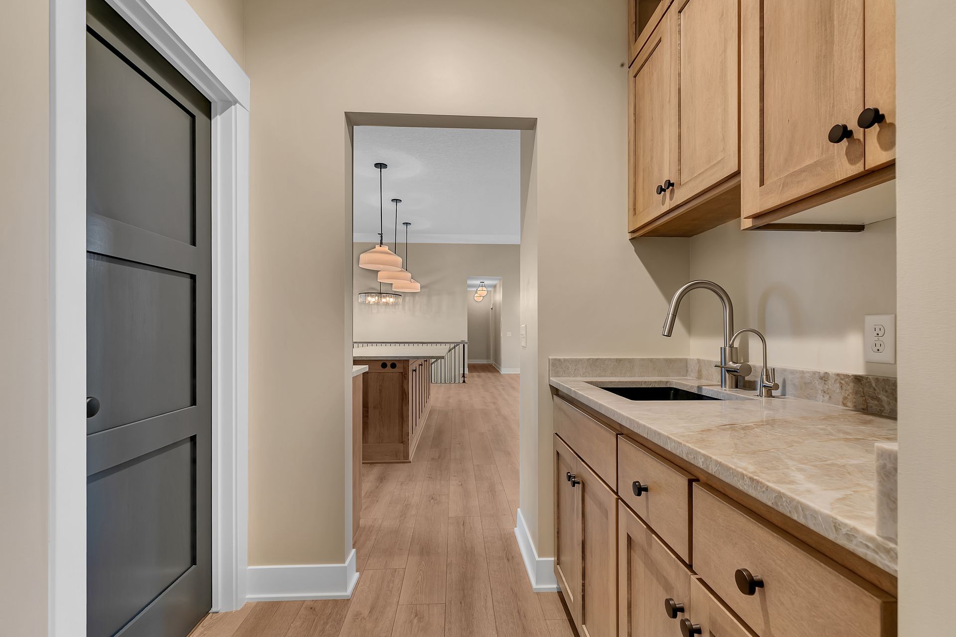 A kitchen with wooden cabinets , granite counter tops , and a sink.
