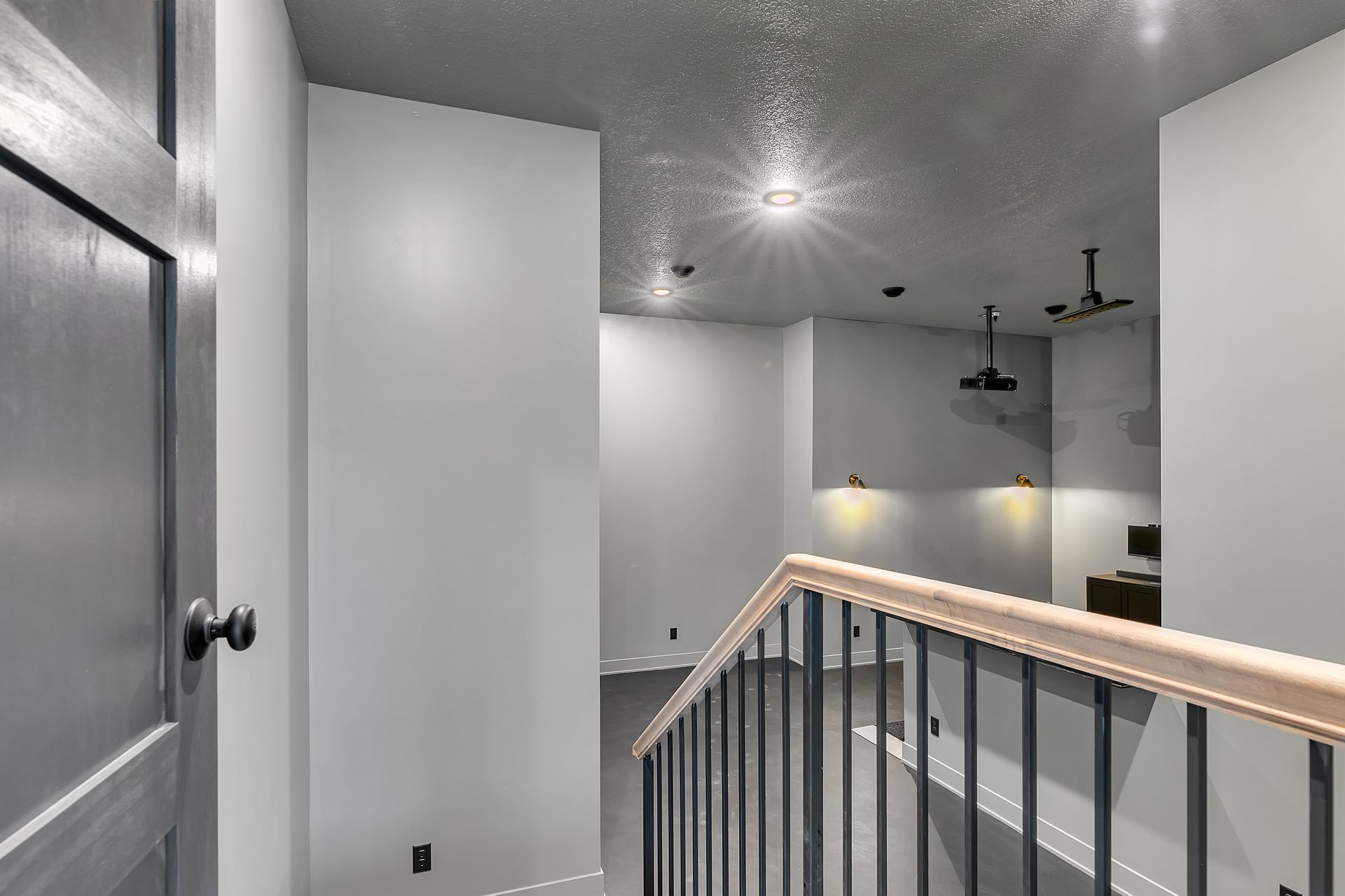 A staircase in a house with a railing and a door.