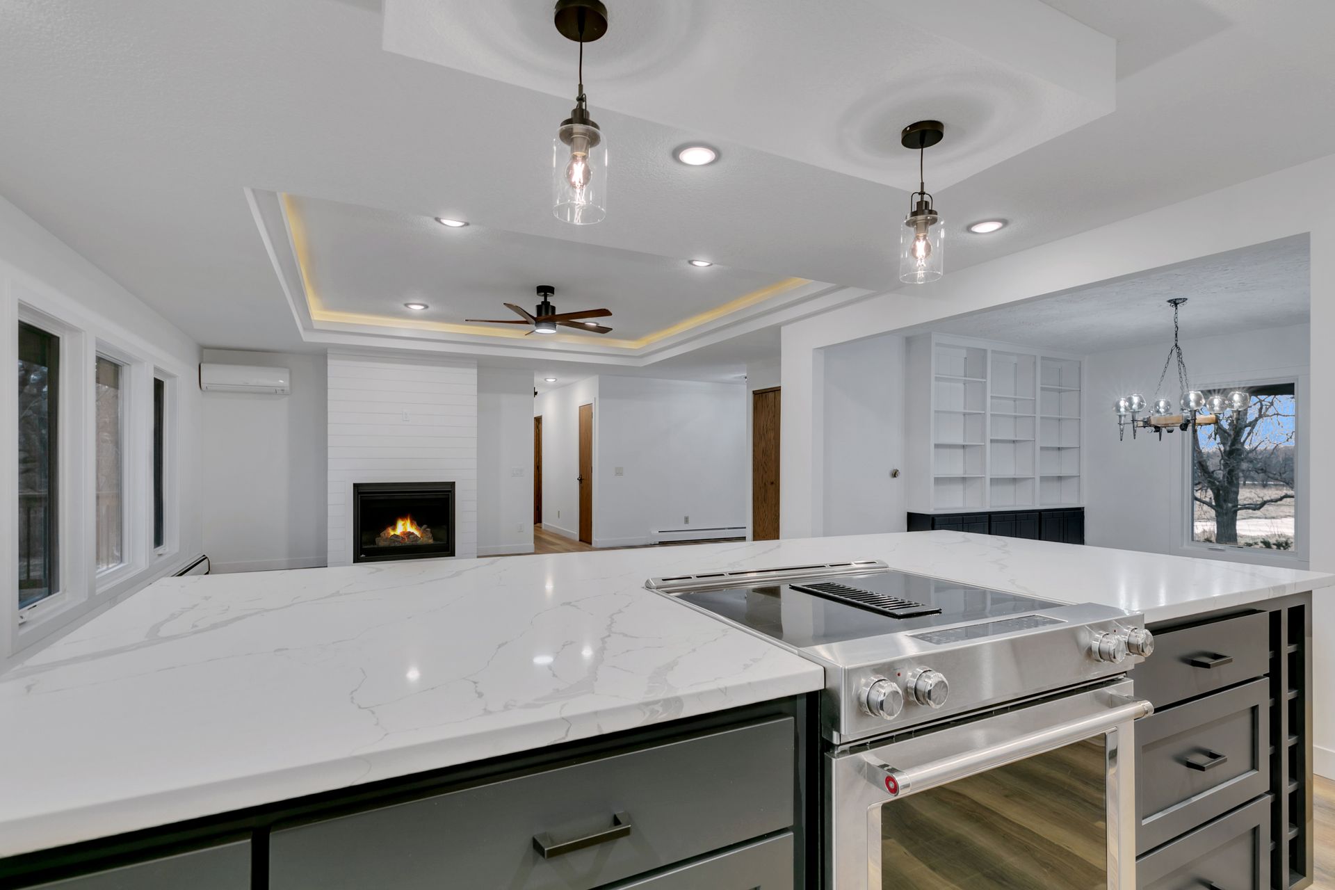 A kitchen with a stove top oven and a fireplace.
