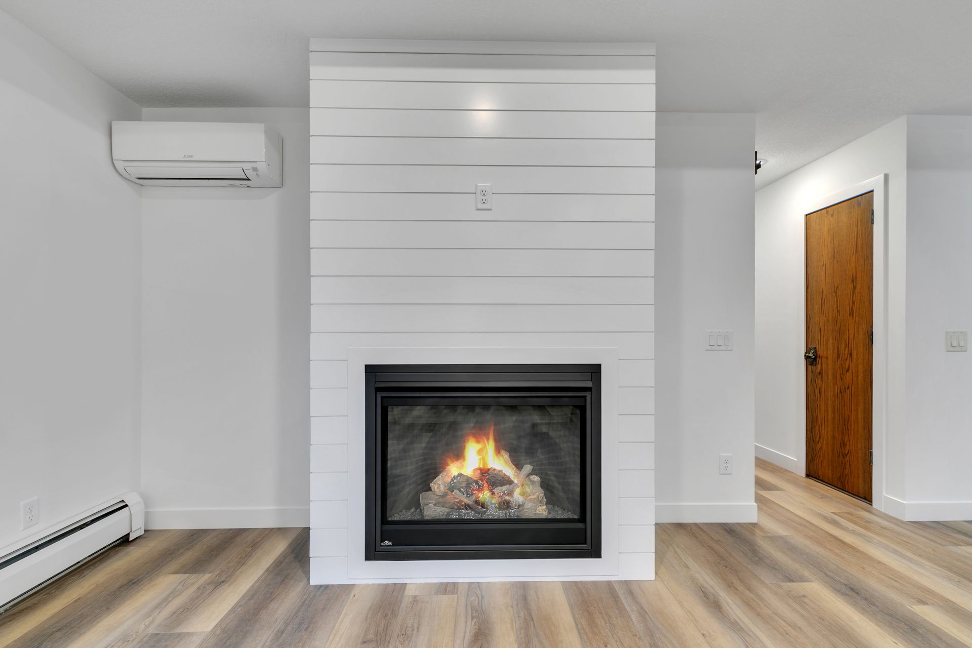 There is a fireplace in the middle of the room.